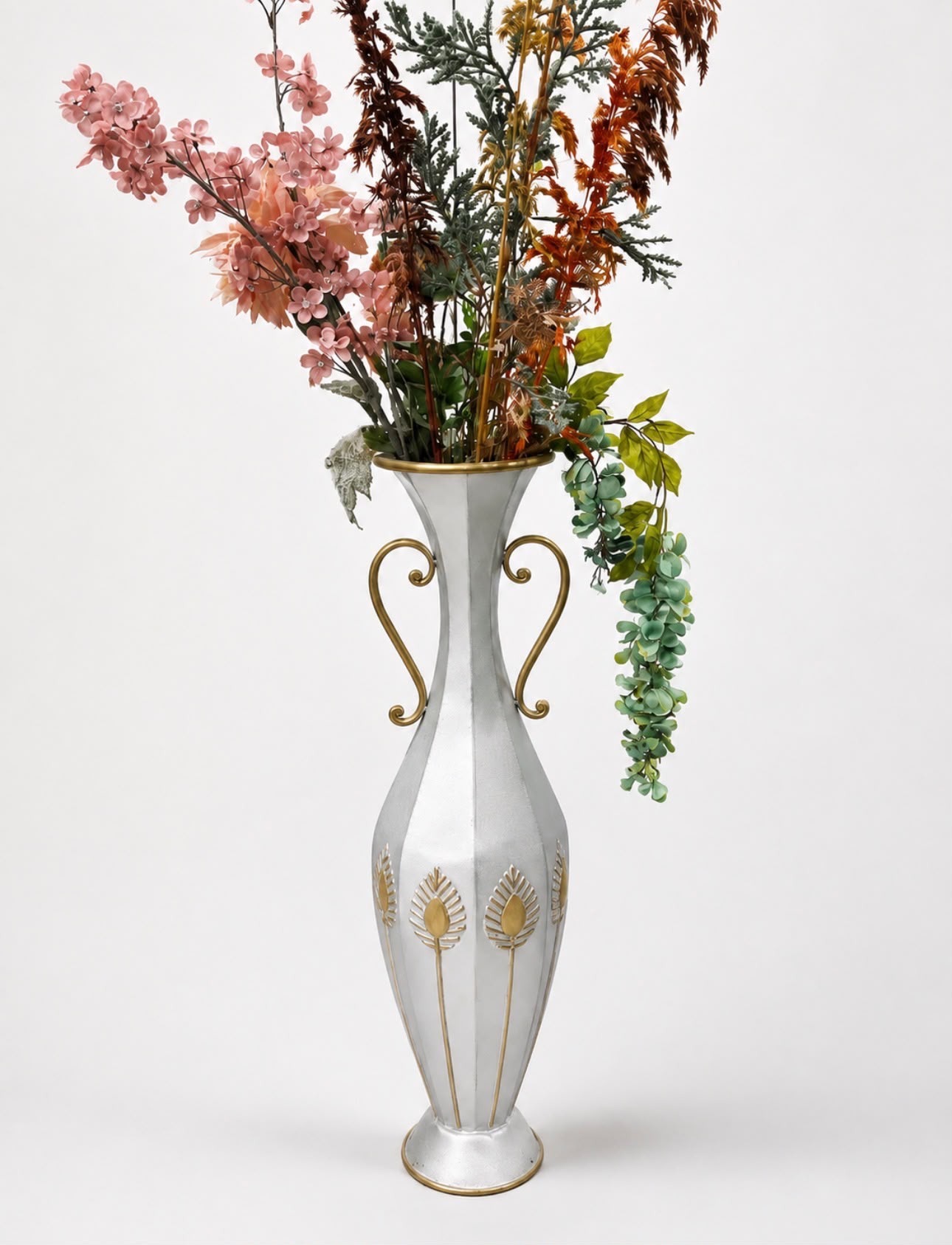 The same vase refinished in brushed silver and gold with a floral arrangement